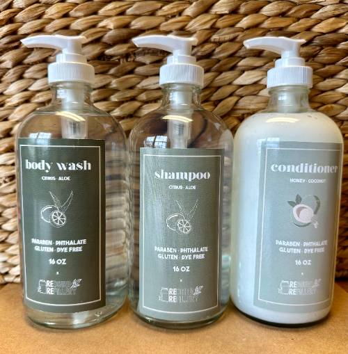 three Redbird Refillable bottles for body wash, shampoo, and conditioner.