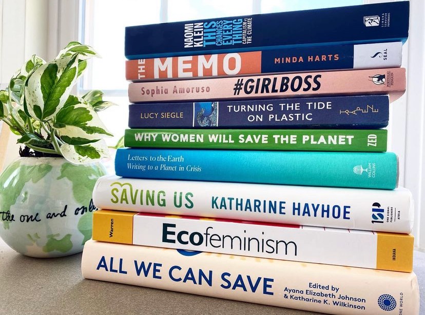 Stack of Sustainability Books with Plant