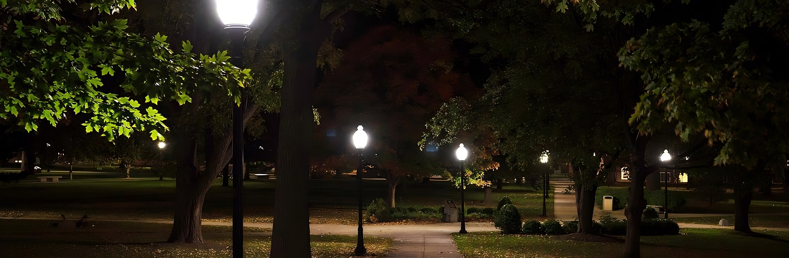 Lamps light up the sidewalks on the quad.