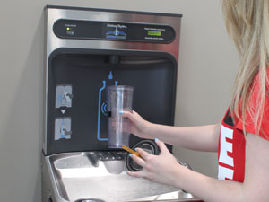 Student fills her water bottle at the a refill station.