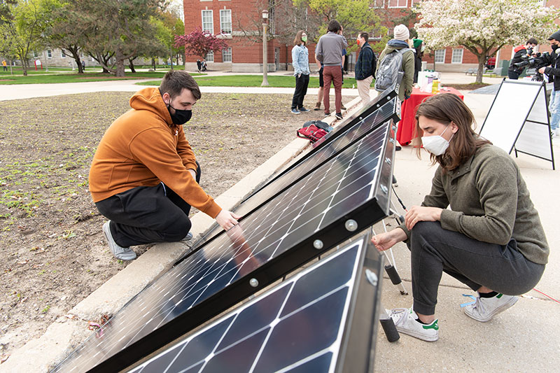 Students inspecting solar panels