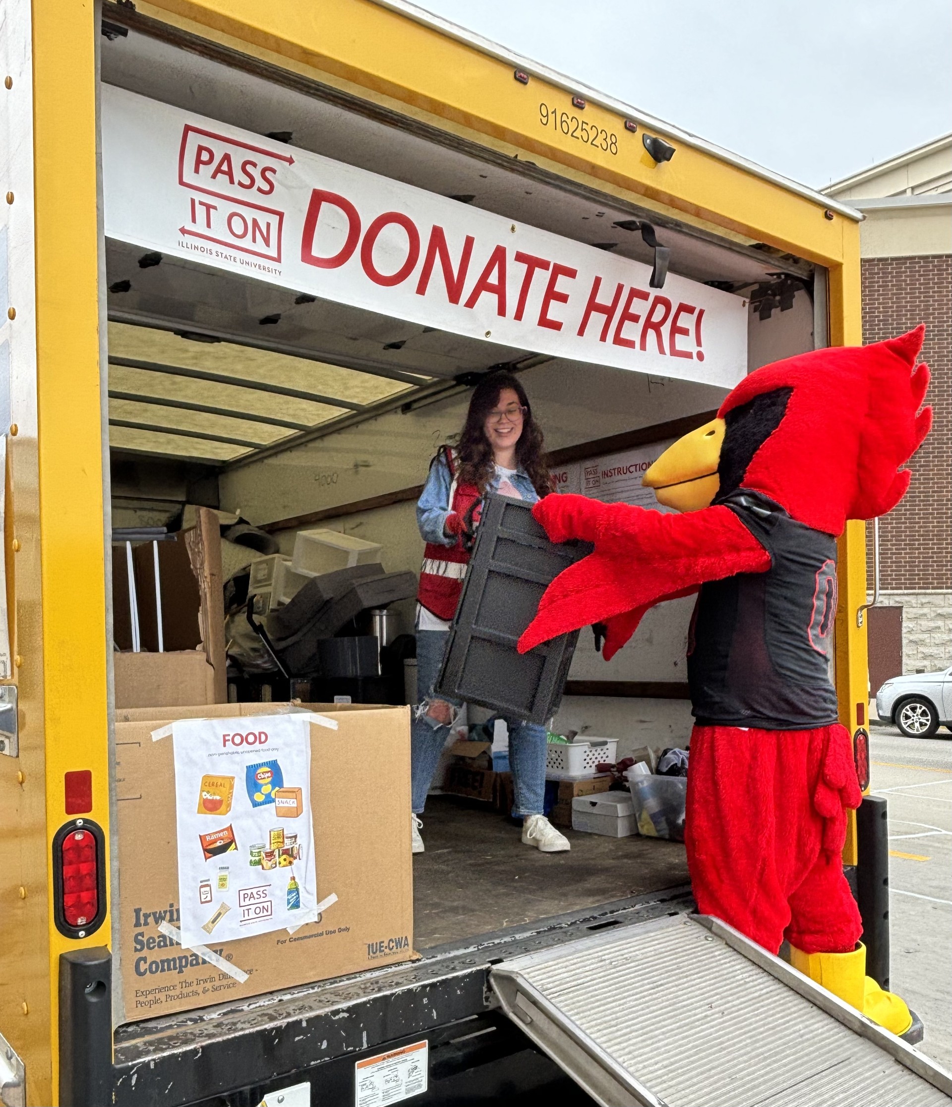 Reggie donating items to the Pass It On donation truck